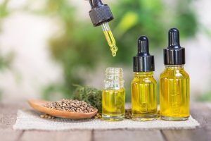 Hemp Seeds In Wooden Spoon And Hemp Essential Oil In Small Glass. Buy CBD Oil In Tuscaloosa