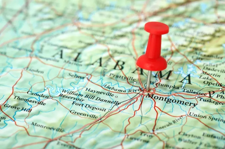 a red push pin on a map of Alabama