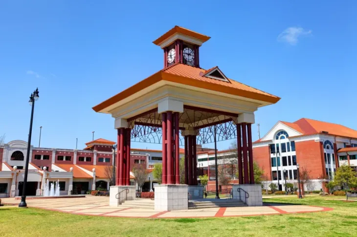 a clock tower in a park in Tuscaloosa, Alabama
