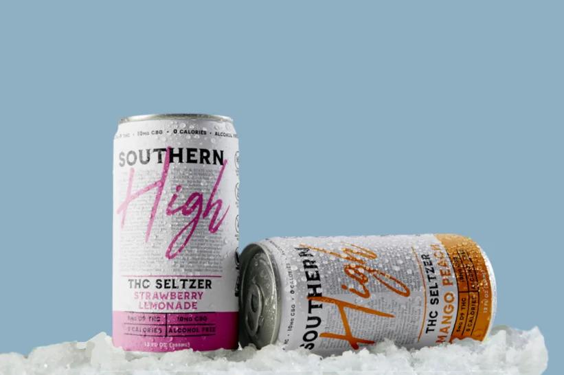 two cans of cannabis beverage in the snow
