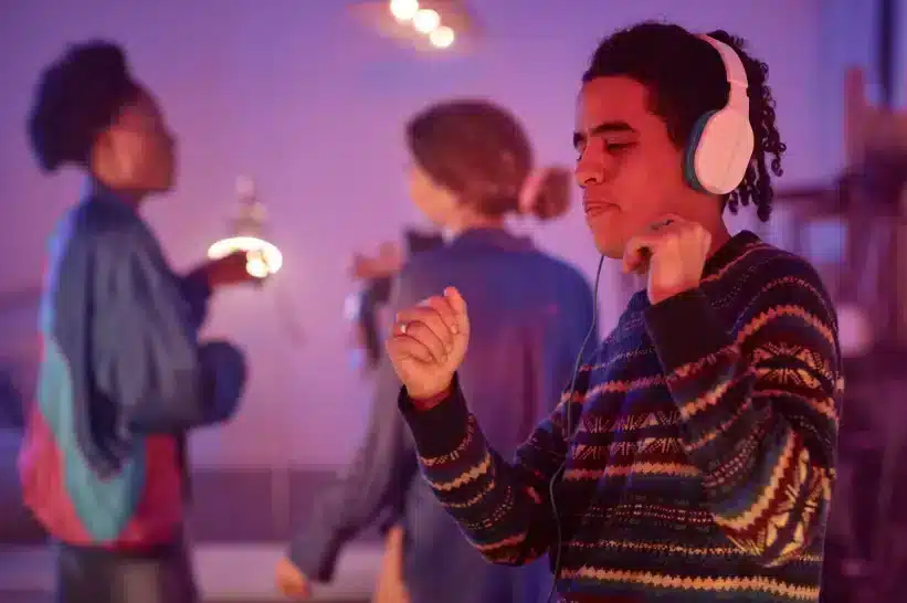 Partygoers wearing headphones dancing on a silent party