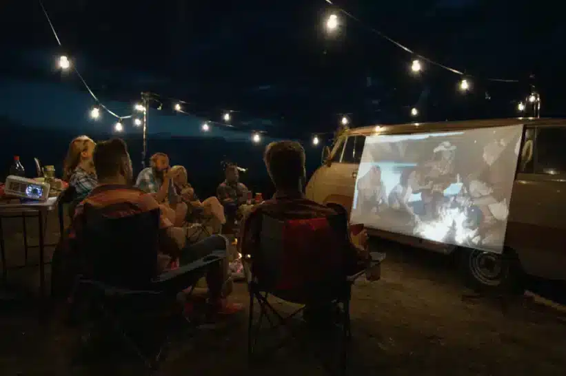 Friends watching from a projector outside
