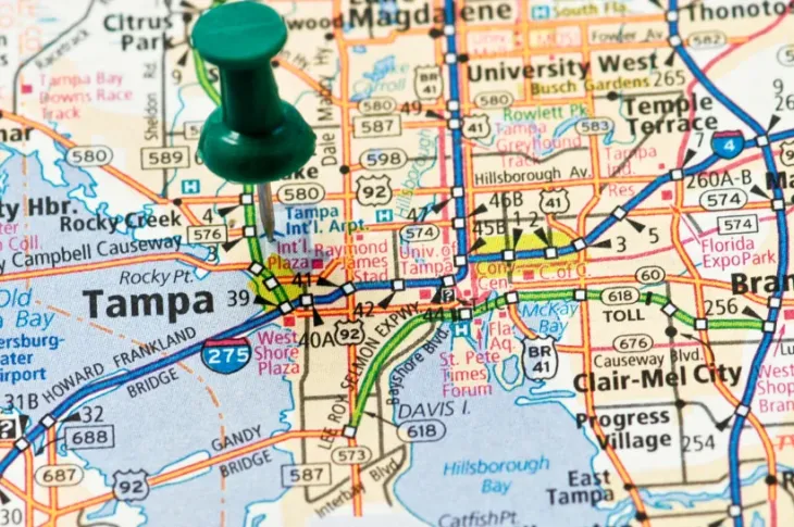 a map with a green push pin on Tampa, Florida