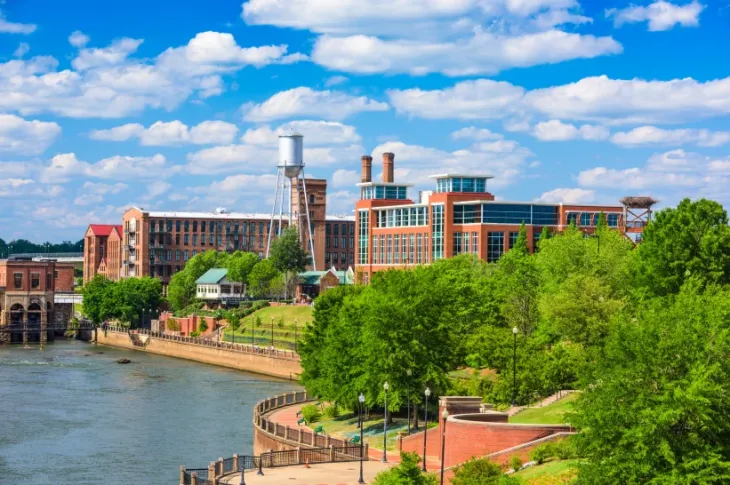 a river with trees and buildings in Columbus, GA