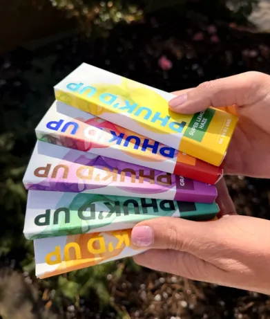 Colorful vape boxes held in hand