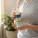 Person holding muscle cream bottle