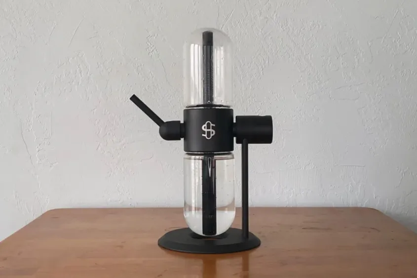Stylish gravity bong on wooden table.