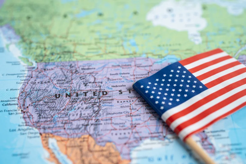 a small American flag on a map of the 50 states