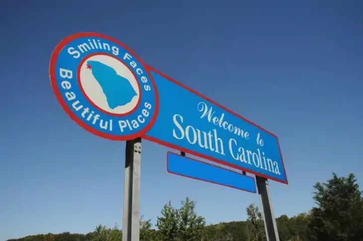 a blue and red sign saying "welcome to south carolina"