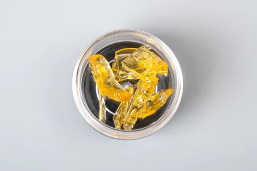 Yellow-colored THCA concentrate in a dish