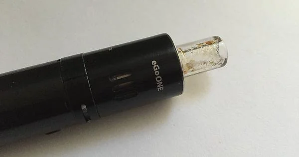a close up of a vaping device with a clogged mouthpiece